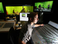 Mark Bushbacher at the Sound Studio’s mixing desk, with images of the band in the background