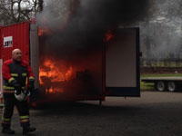 The fire takes hold of the reconstructed bedsit set up in the container. Link to View the pictures.