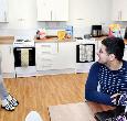 Two students talking in a kitchen at East Parkside Village