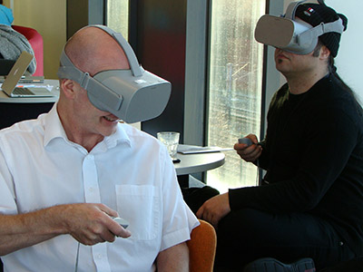Professor Denis Martin (left) trying some of the VR technology. Link to Pioneering research project extended to investigate Covid-19 side effects.
