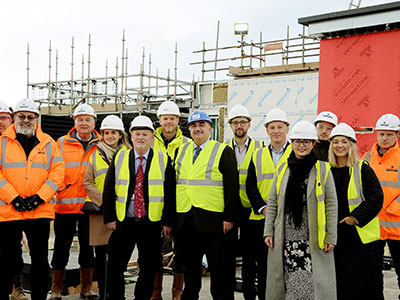 Members of staff from Teesside University, Robertson Construction and GSSArchitecture celebrate a major milestone in the NZIIC development.