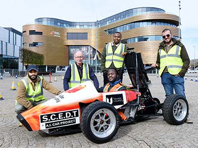 Pictured in the car is student Oluwafemi Akhigbe, with (left to right) student Kenny Omoworare, and academics from the School of Computing, Engineering and Digital Technologies, Alex Ellin, Chris Ogwumike and Hayder Hammood.. Link to Pictured in the car is student Oluwafemi Akhigbe, with (left to right) student Kenny Omoworare, and academics from the School of Computing, Engineering and Digital Technologies, Alex Ellin, Chris Ogwumike and Hayder Hammood..