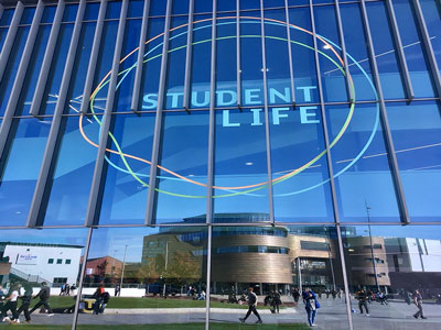 A view of the Student Life Building in the campus heart of Teesside University. The Curve building is reflected in the windows.. Link to A view of the Student Life Building in the campus heart of Teesside University. The Curve building is reflected in the windows..