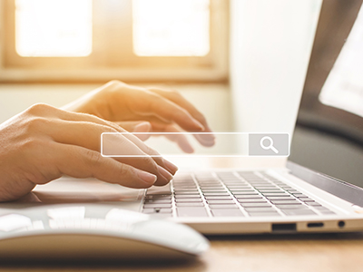 Person using a laptop (image shows laptop, mouse, hands in the background with a search bar in the foreground). Link to Develop your Systematic Literature Searching Skills – Health Students (February 2026).