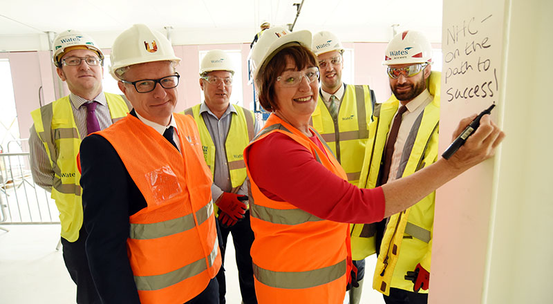 Staff from Teesside University and Wates Construction celebrate the topping out of the National Horizons Centre