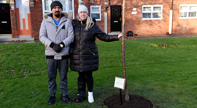 Tan and Michelle Hanif with the memorial tree for Michael. 