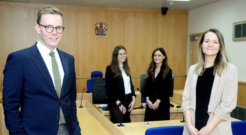 ULaw Dean of Leeds, Sheffield and Newcastle campuses Matthew Tomlinson (left) and ULaw Newcastle Campus Manager Larissa Hope (right) join Teesside University’s Hannah Sellers (centre left) and Angela King (centre right) in the replica courtroom. 