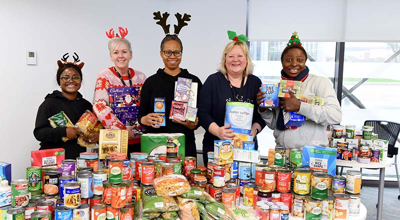 Teesside University volunteers with some of the donated food collected as part of the Festive Food Drive