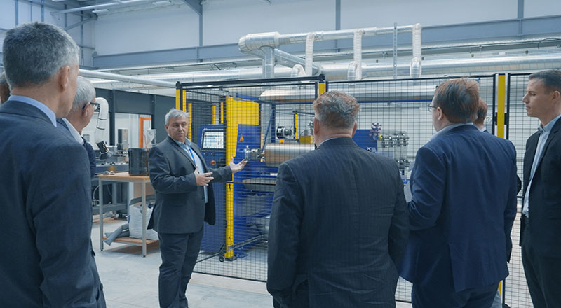 Delegates being shown round the new engineering hall at its opening. 