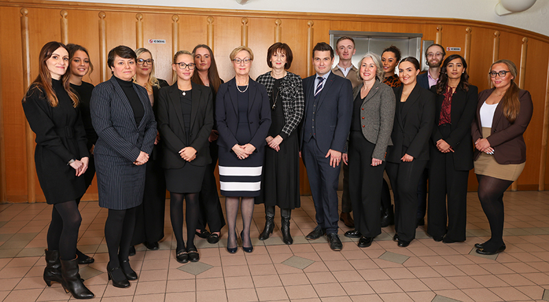 (Centre) Her Honour Judge Gillian Matthews KC, District Judge Sara Keating and His Honour Judge Harvey Murray together with staff and students from Teesside University Law Clinic at Teesside Combined Court Centre.