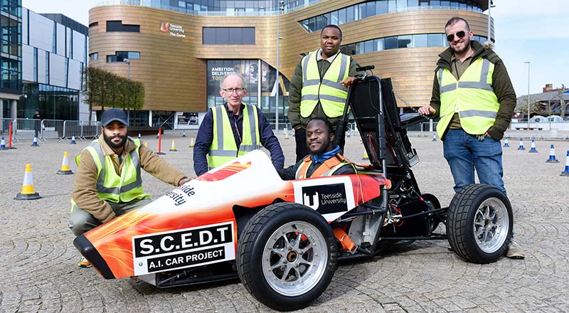 Pictured in the car is student Oluwafemi Akhigbe, with (left to right) student Kenny Omoworare, and academics from the School of Computing, Engineering and Digital Technologies, Alex Ellin, Chris Ogwumike and Hayder Hammood.. Link to Pictured in the car is student Oluwafemi Akhigbe, with (left to right) student Kenny Omoworare, and academics from the School of Computing, Engineering and Digital Technologies, Alex Ellin, Chris Ogwumike and Hayder Hammood..