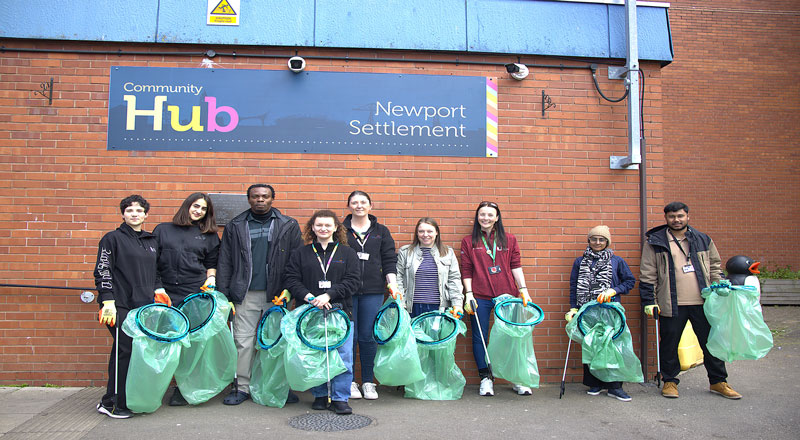 A group of volunteers standing outside Newport Community hub, ready to do a litter pick. 