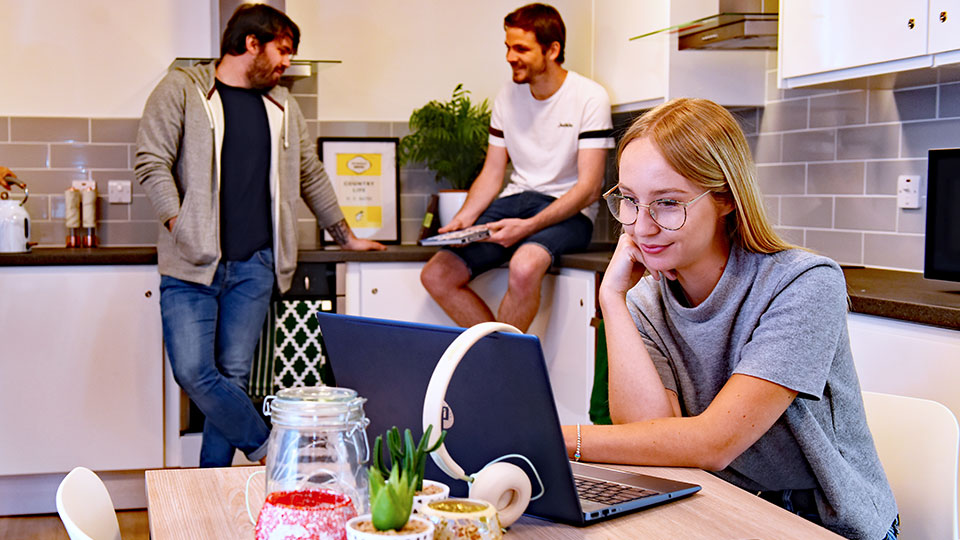 Students gather in a Teesside University Accommodation kitchen