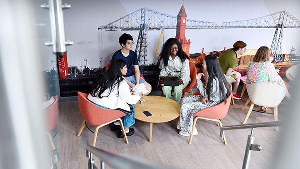International students sitting and studying at Teesside University