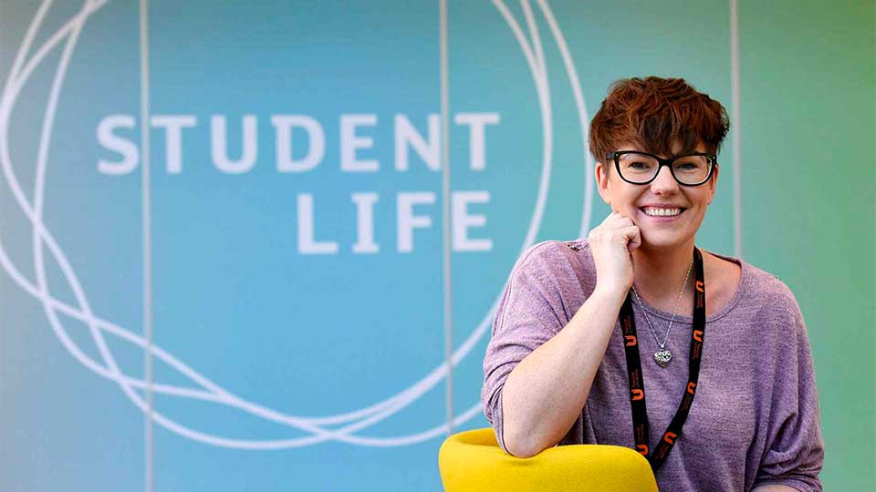 Student sitting in Student Life building