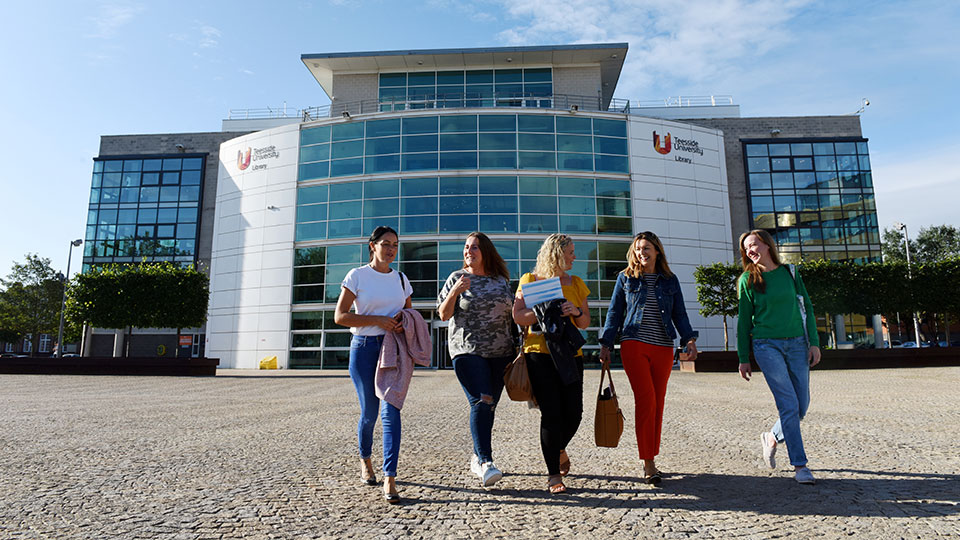 students walking through the campus heart