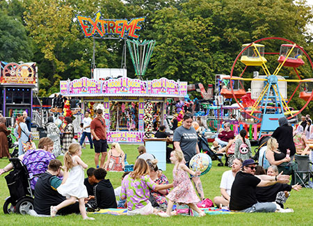 Mala festival attenders walking through the festival stands, eating and dancing