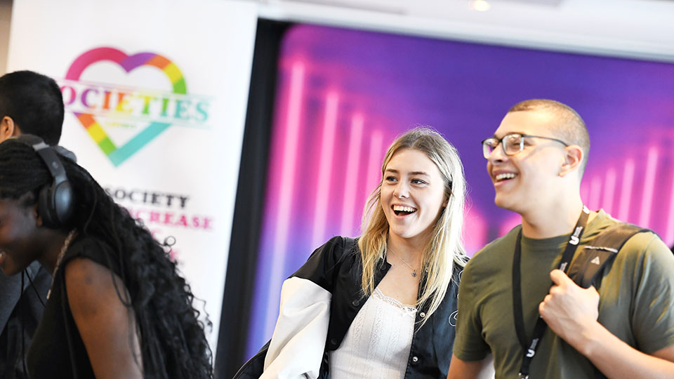 Students at a Teesside University Students’ Union societies fair smiling and socialising