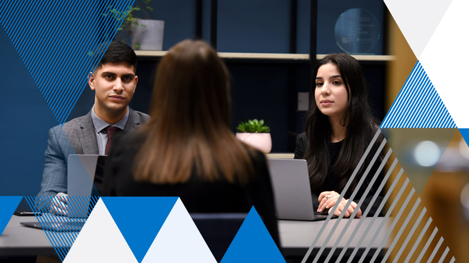 students chatting in a blue office