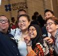 Five people smiling and taking a selfie together