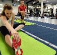 Students training with fitness equipment in the gym at Teesside University