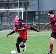 Students playing football on the pitch at Teesside University