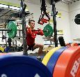 Student working out with free weights equipment at the Teesside University gym