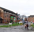 Students walking outside the Woodlands Hall student accommodation building at Teesside University