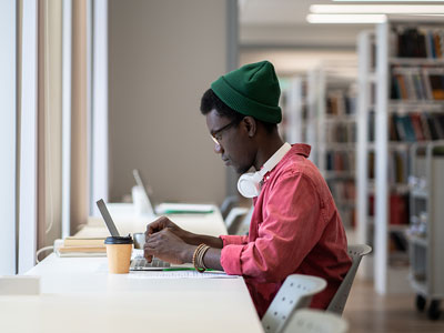 An image of a student studying in a library. Link to SCONUL Access Scheme.