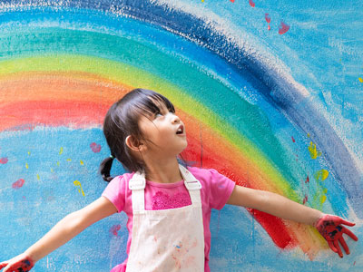 An image of a child looking at a painted rainbow. Link to Do Good Feel Good: Send Smiles Through Post Pals, 24 September.