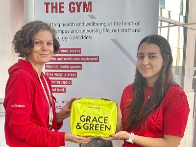 Vik Brown and Samantha Soto Pupillo with one of the period kits  . Link to Period packs provided to support student sports participation.