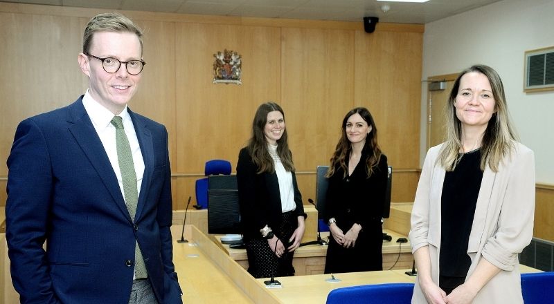 ULaw Dean of Leeds, Sheffield and Newcastle campuses Matthew Tomlinson (left) and ULaw Newcastle Campus Manager Larissa Hope (right) join Teesside University’s Hannah Sellers (centre left) and Angela King (centre right) in the replica courtroom. 