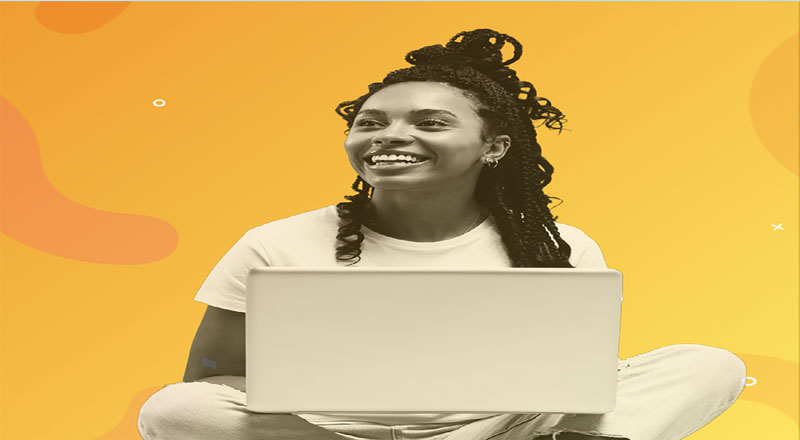 An image of a smiling student with a laptop. The background is yellow. Link to An image of a smiling student with a laptop. The background is yellow.