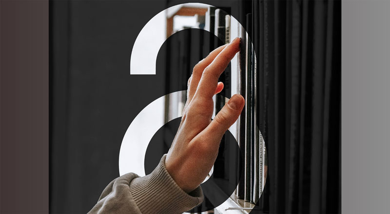 An image of a hand reaching for a book, with the open access logo displayed behind