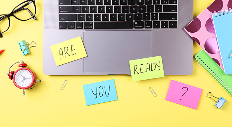 An image of various exam related materials on a table, with the words 