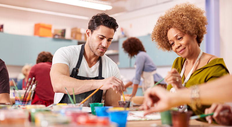 Two people painting at a table 