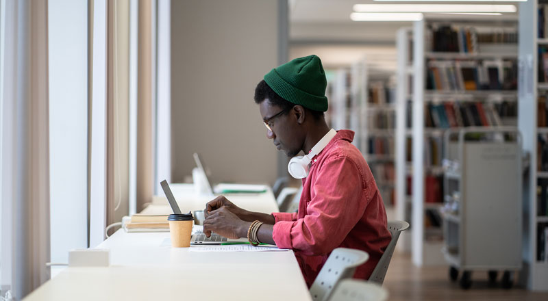 An image of a student studying in a library