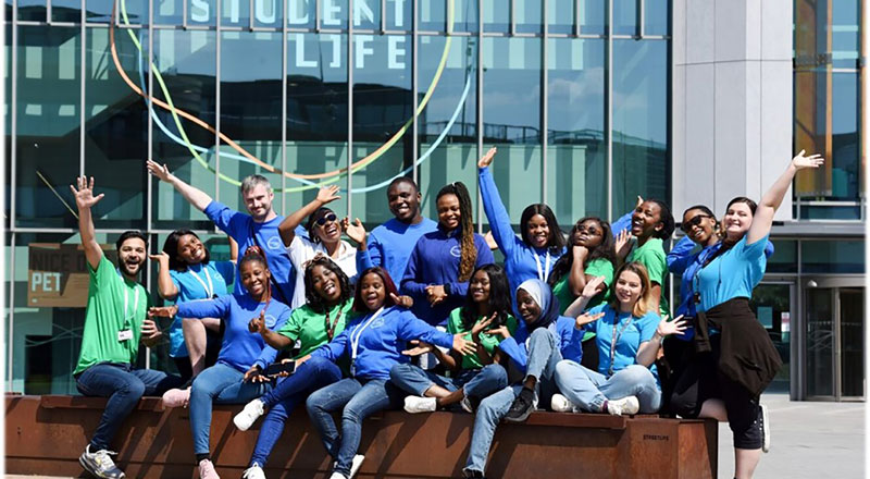 An image of a group of Student Engagement Assistants outside of the Student Life building