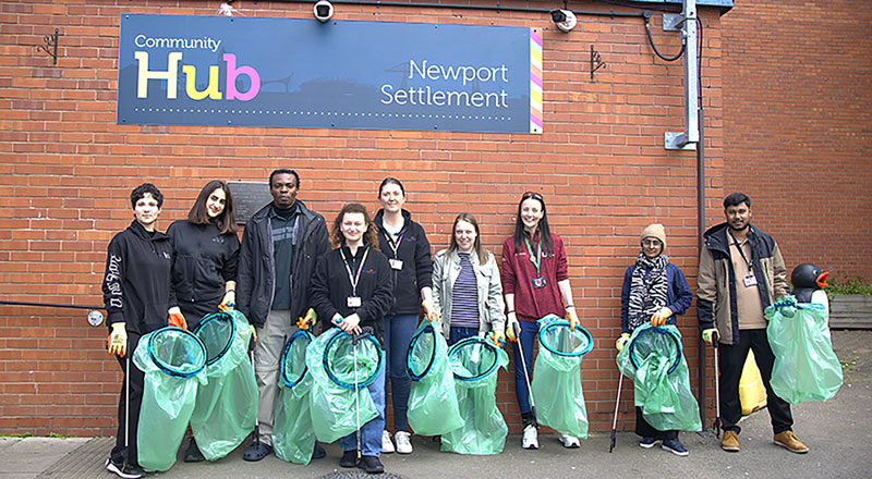 An image of a group of volunteers litter picking, outside Newport Settlement Community Hub