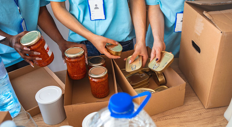 An image of volunteers packing items at a food bank