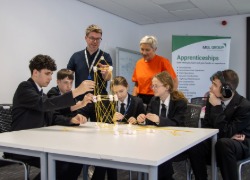 Michelle Henderson (NESF) watches students build a tower