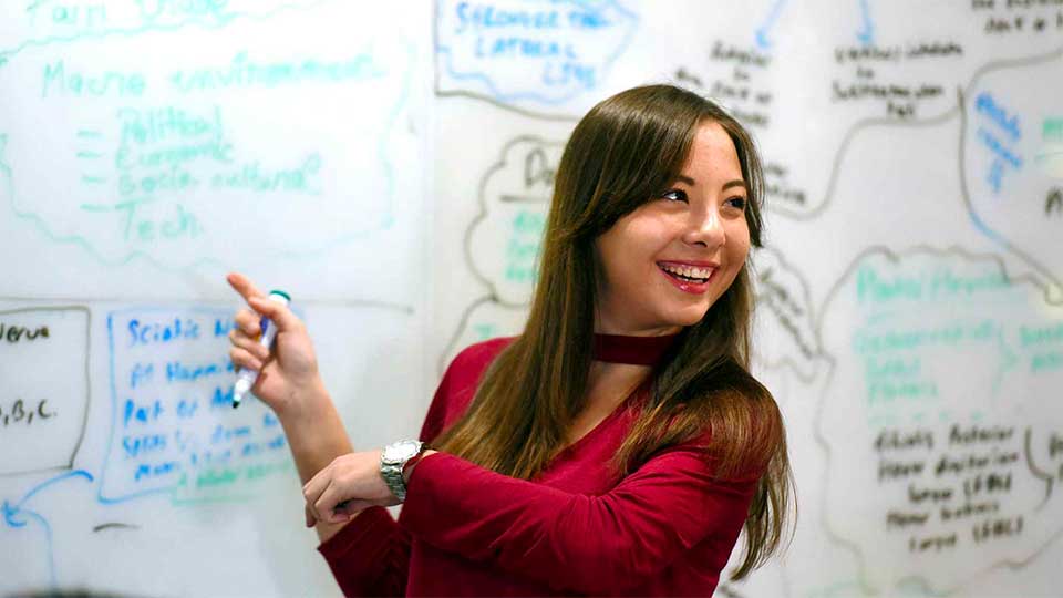 Student in front of a whiteboard