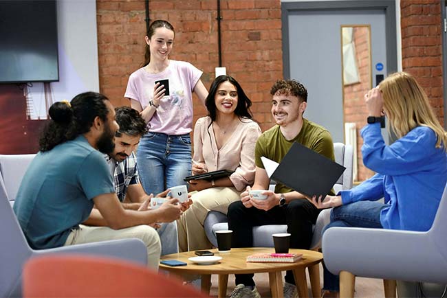 Teesside University students sitting and talking on campus