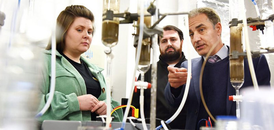 Incorporating waste materials into low-carbon concrete production: from laboratory to commercial scale