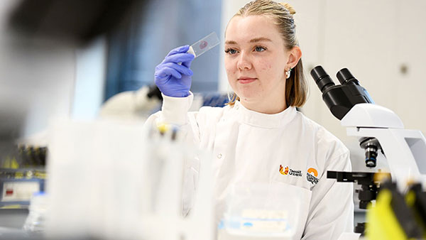 Female scientist working in a laboratory setting, focused on scientific research