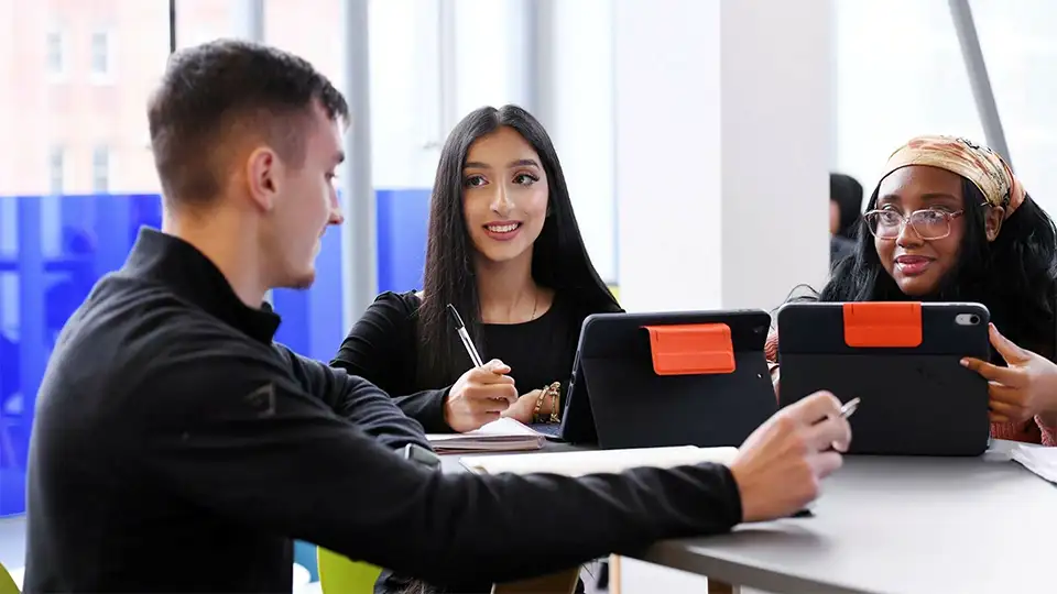 Students in a group with iPads