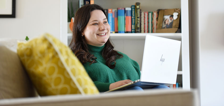Student sit with a laptop