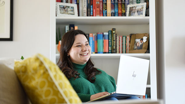 Student sit with a laptop