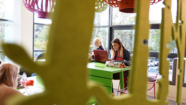 Students sit with computers at teesside university library