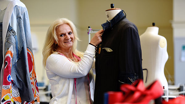 Fashion design mature student tailoring her clothes